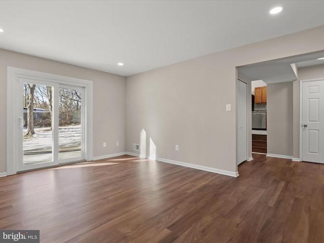 spare room with dark wood-type flooring