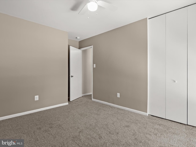 unfurnished bedroom with light colored carpet, a closet, and ceiling fan