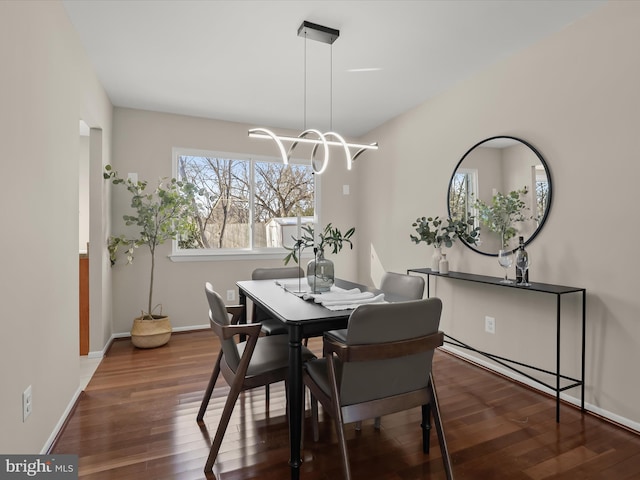 dining room featuring an inviting chandelier and dark hardwood / wood-style flooring