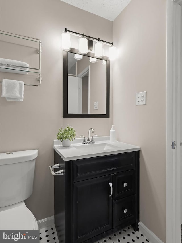 bathroom with vanity, tile patterned floors, and toilet