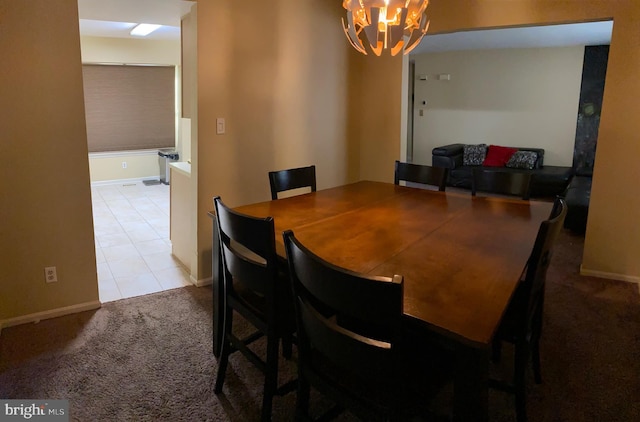 dining space with light colored carpet and a notable chandelier