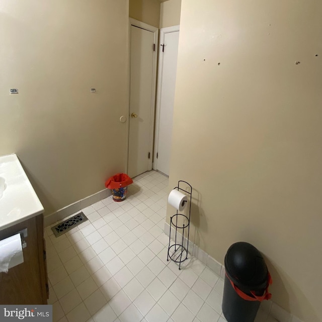 bathroom with tile patterned flooring and vanity