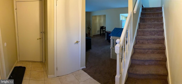 staircase featuring tile patterned flooring