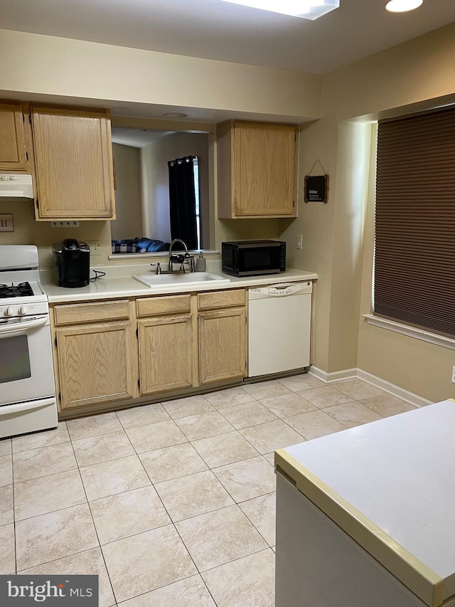 kitchen featuring sink, light tile patterned floors, and white appliances