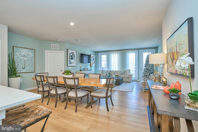 dining space with light hardwood / wood-style flooring