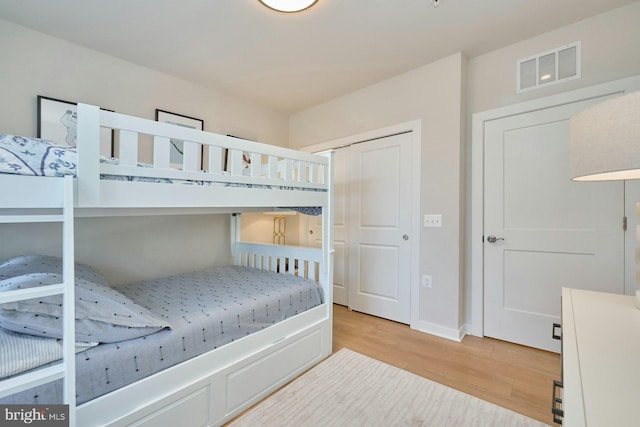 bedroom featuring light wood-type flooring and a closet