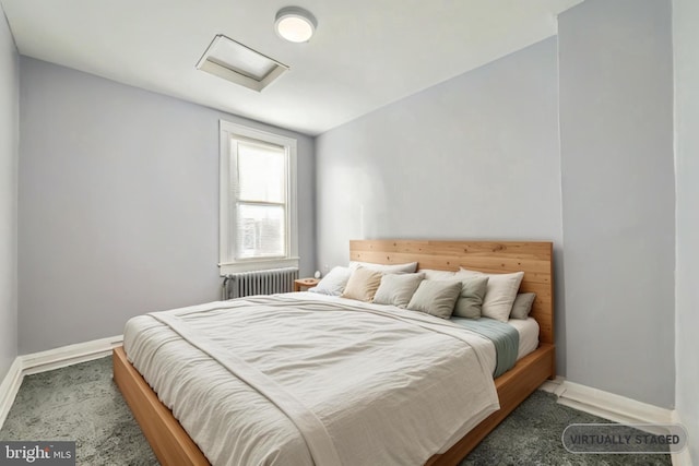 bedroom featuring radiator heating unit and dark colored carpet