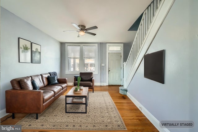 living room featuring ceiling fan and hardwood / wood-style floors