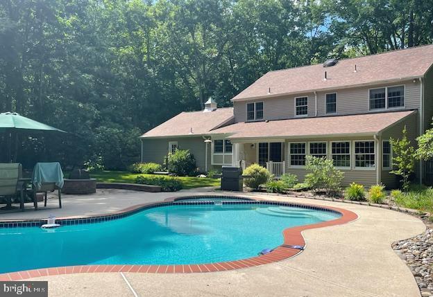 outdoor pool with a patio area