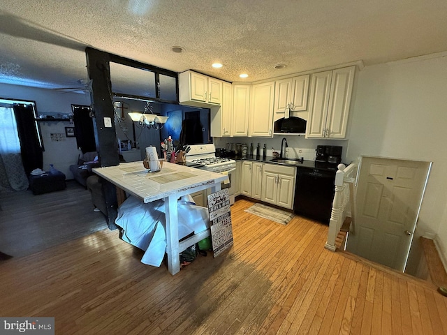 kitchen featuring white cabinetry, white gas range, black dishwasher, sink, and tile counters