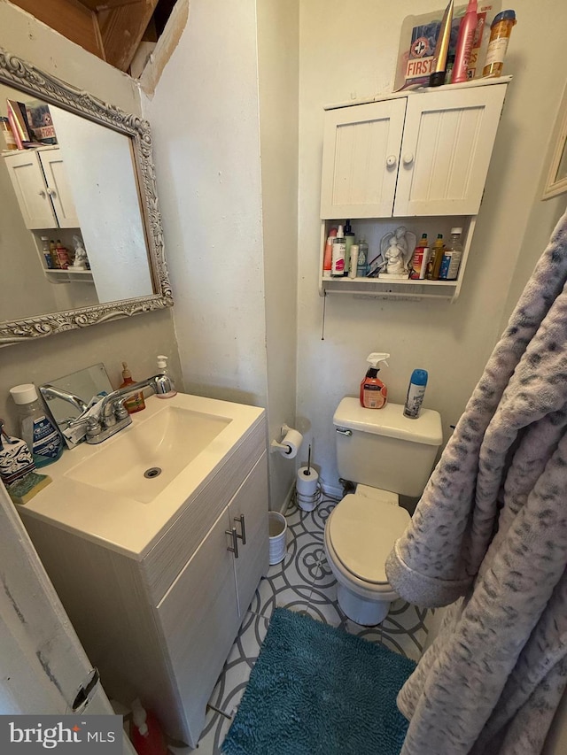 bathroom featuring vanity and toilet