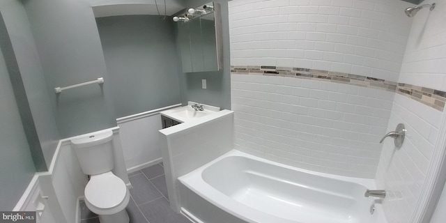 full bathroom with tiled shower / bath, vanity, toilet, and tile patterned flooring