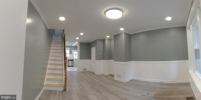 corridor featuring ornamental molding and light wood-type flooring