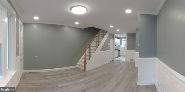 interior space featuring hardwood / wood-style flooring and ornamental molding