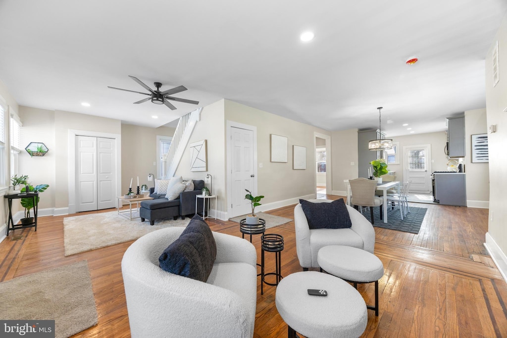 living room featuring ceiling fan and light hardwood / wood-style flooring