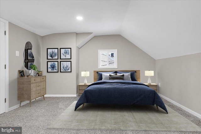 carpeted bedroom with vaulted ceiling