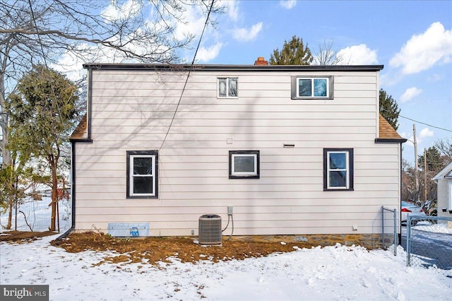 snow covered property featuring cooling unit