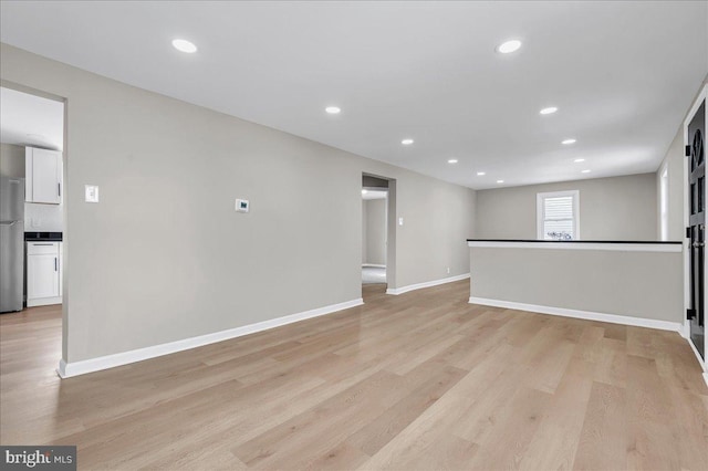 unfurnished living room with light hardwood / wood-style flooring