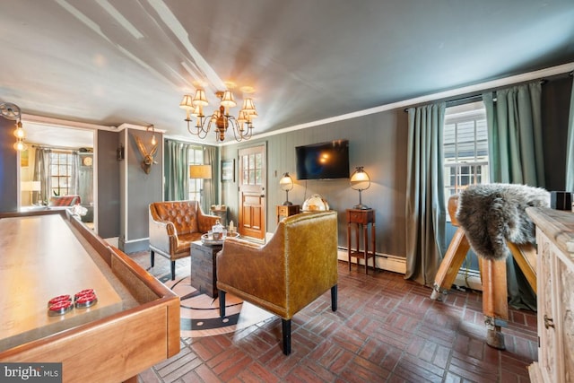 living area featuring crown molding, a chandelier, and a baseboard heating unit