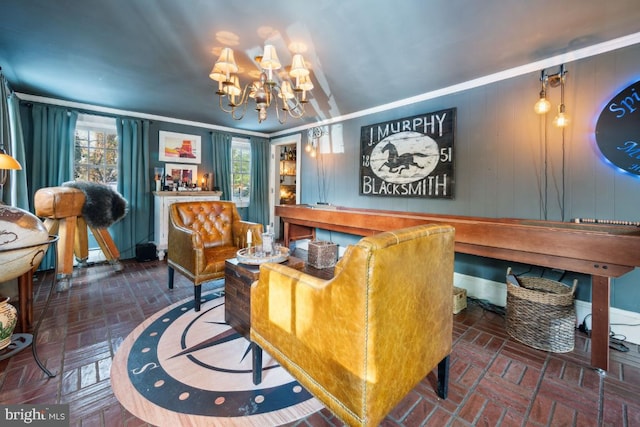 interior space with an inviting chandelier, crown molding, and wooden walls