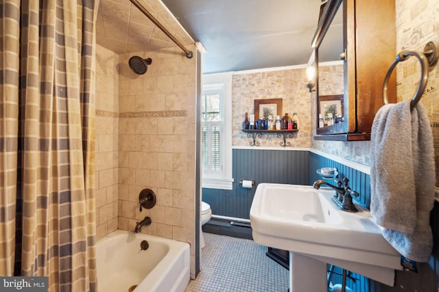 bathroom featuring shower / bath combo with shower curtain, toilet, and wood walls