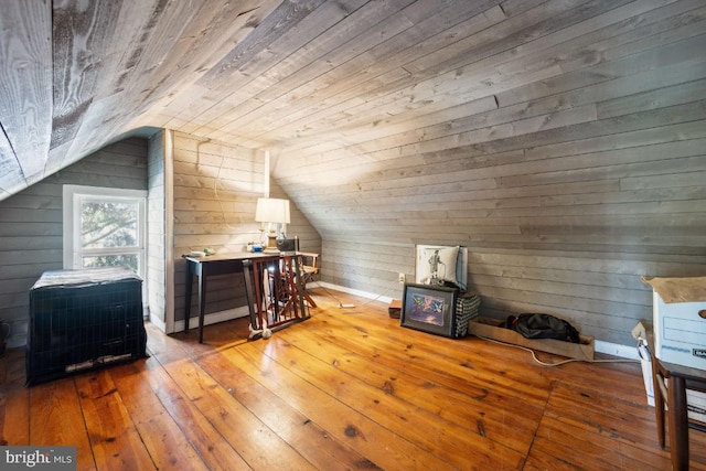 additional living space with hardwood / wood-style flooring, vaulted ceiling, wood ceiling, and wood walls