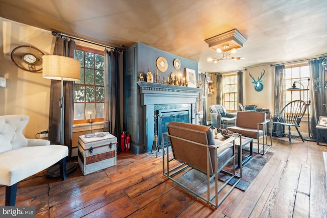 sitting room featuring a notable chandelier, wood-type flooring, and plenty of natural light