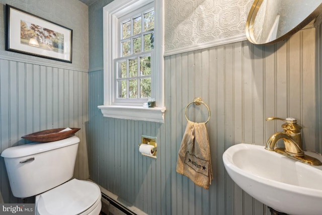 bathroom featuring sink, a baseboard radiator, and toilet