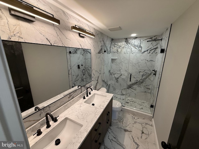 bathroom with walk in shower, vanity, and toilet