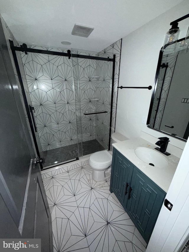 bathroom with vanity, toilet, and an enclosed shower