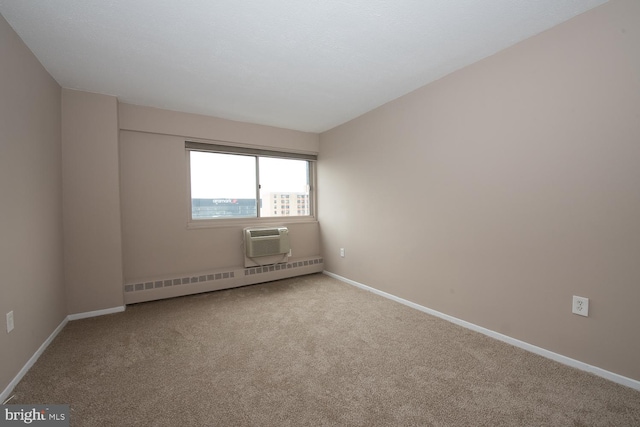 spare room featuring a wall unit AC, light colored carpet, and baseboard heating