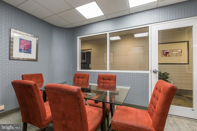 dining space with a paneled ceiling