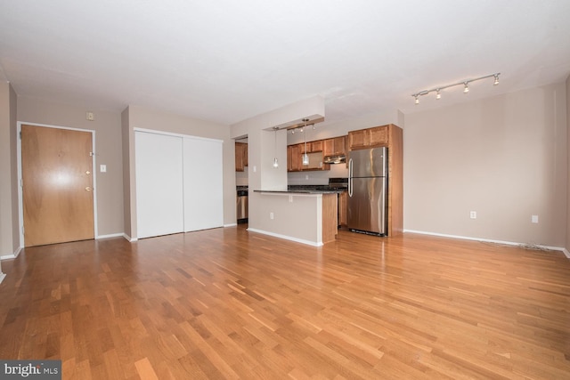 unfurnished living room featuring light wood-type flooring