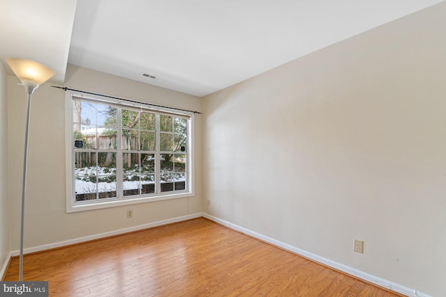 spare room featuring light hardwood / wood-style floors