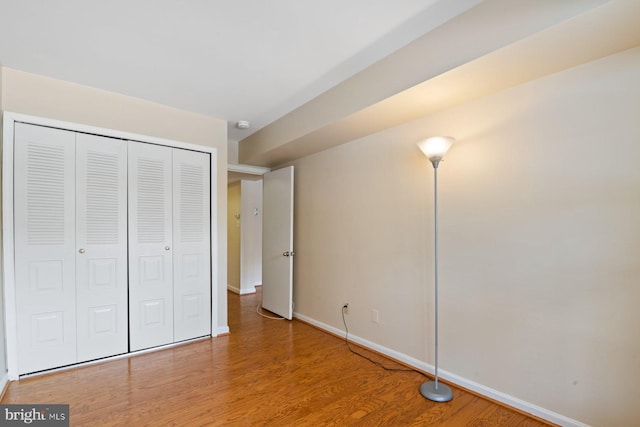 unfurnished bedroom with hardwood / wood-style floors