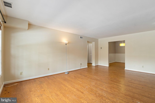 spare room featuring light wood-type flooring