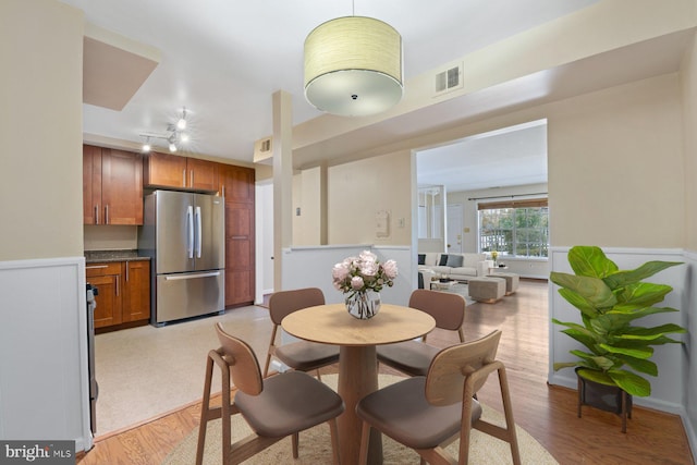 dining space with light hardwood / wood-style flooring