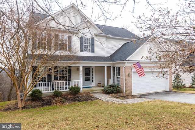 view of front of home featuring brick siding, a shingled roof, covered porch, an attached garage, and driveway