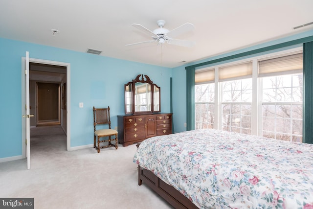 bedroom featuring light colored carpet, visible vents, ceiling fan, and baseboards