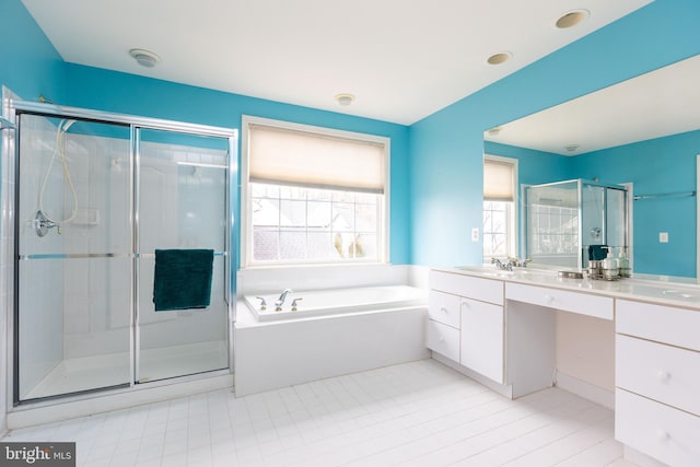 full bathroom featuring double vanity, a garden tub, a shower stall, and a sink