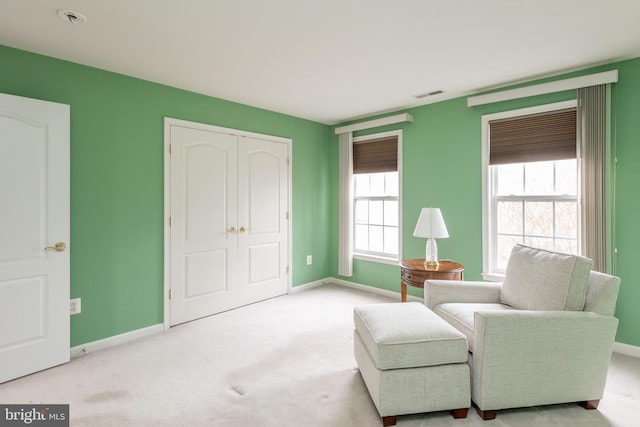 sitting room featuring baseboards, visible vents, and carpet flooring