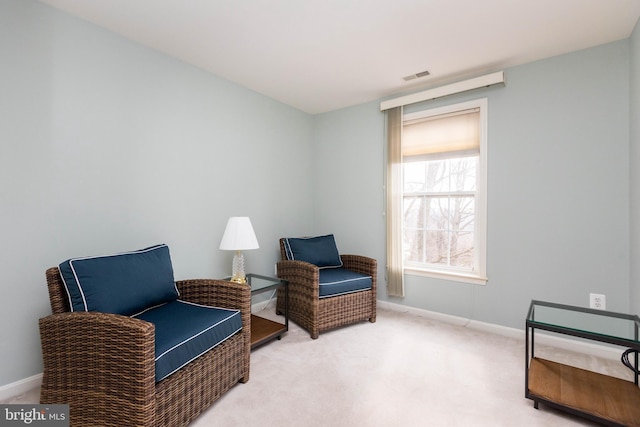 sitting room featuring carpet floors, visible vents, and baseboards