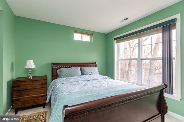 carpeted bedroom featuring baseboards and visible vents