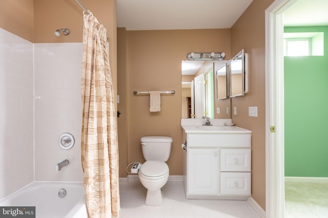 bathroom featuring toilet, vanity, baseboards, tile patterned floors, and shower / bath combo