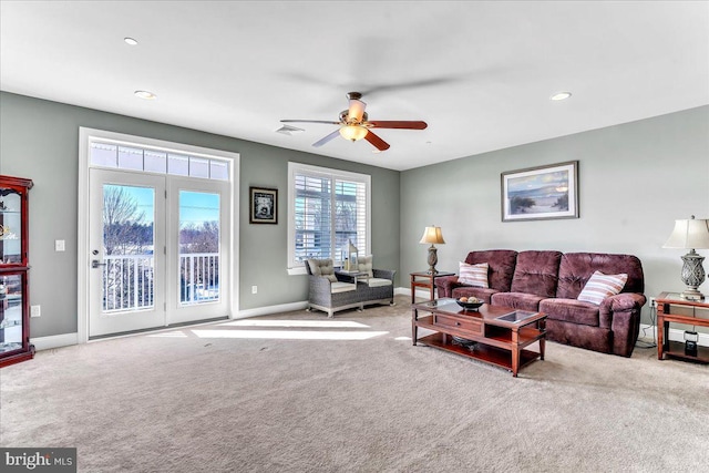 carpeted living room featuring ceiling fan