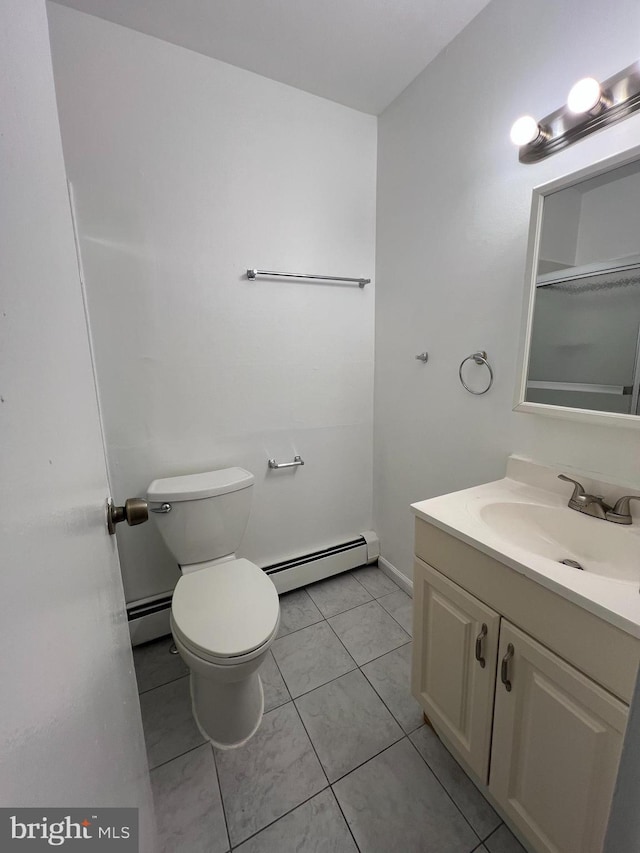 bathroom with baseboard heating, tile patterned floors, toilet, and vanity