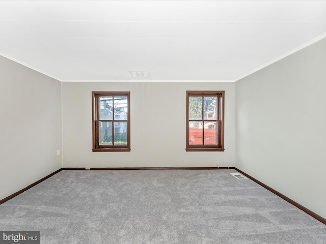 unfurnished room featuring crown molding and light colored carpet