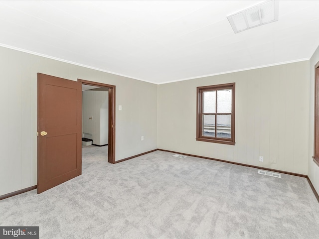 carpeted spare room with ornamental molding