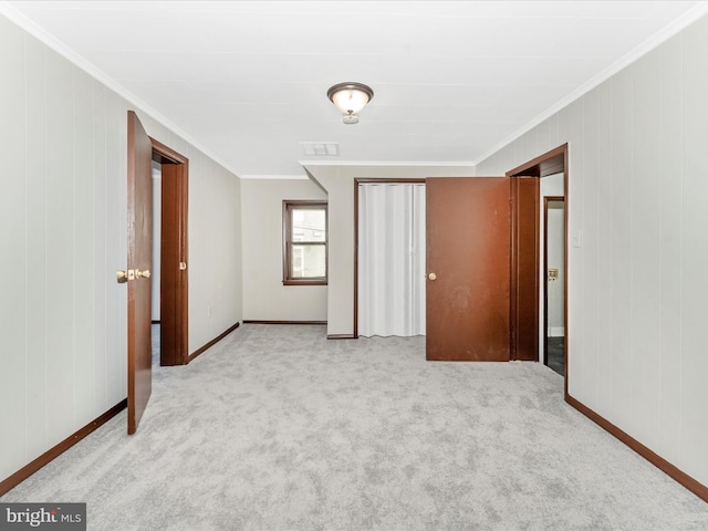 unfurnished bedroom featuring light carpet and ornamental molding