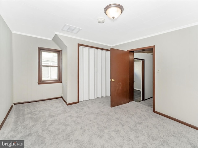 unfurnished bedroom with crown molding and light colored carpet